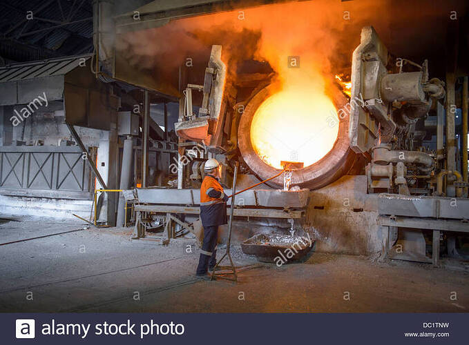 worker-raking-liquid-aluminum-from-furnace-at-recycling-plant-DC1TNW